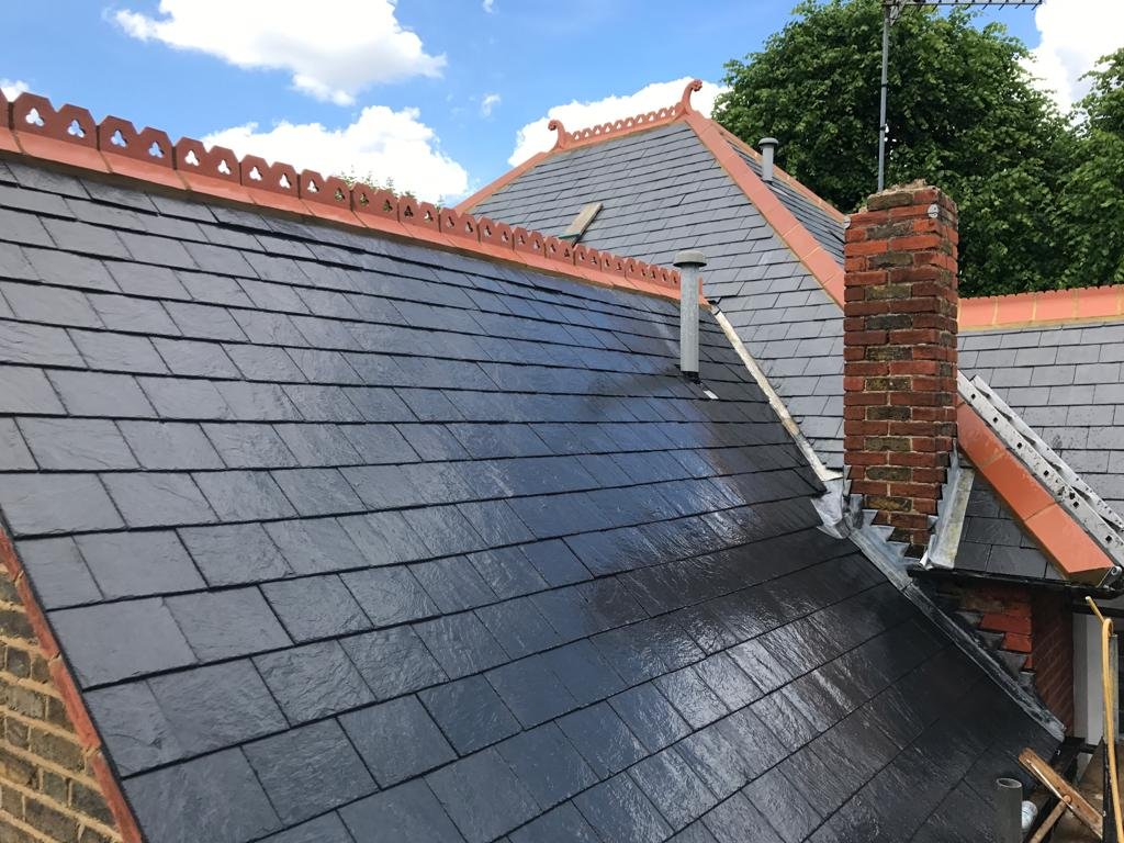 Dark slate-style pitched roof with decorative terracotta ridge detail
